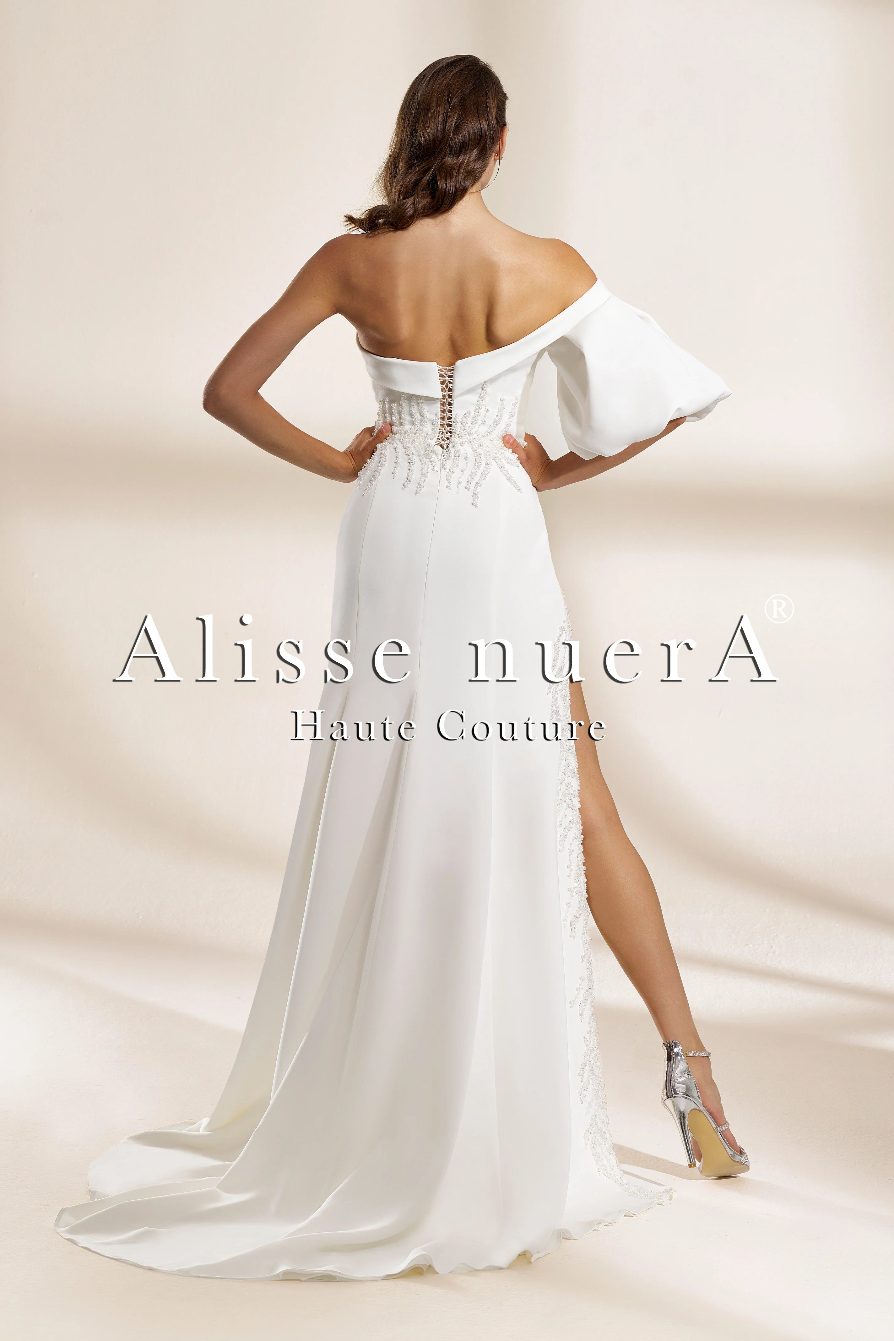 one shoulder backless wedding dress Simple yet bold and captivating! This one-shoulder sheath masterpiece features a striking open back and chic asymmetrical neckline, adorned with delicate ribbon-tie details that balance minimalism with an artistic edge and