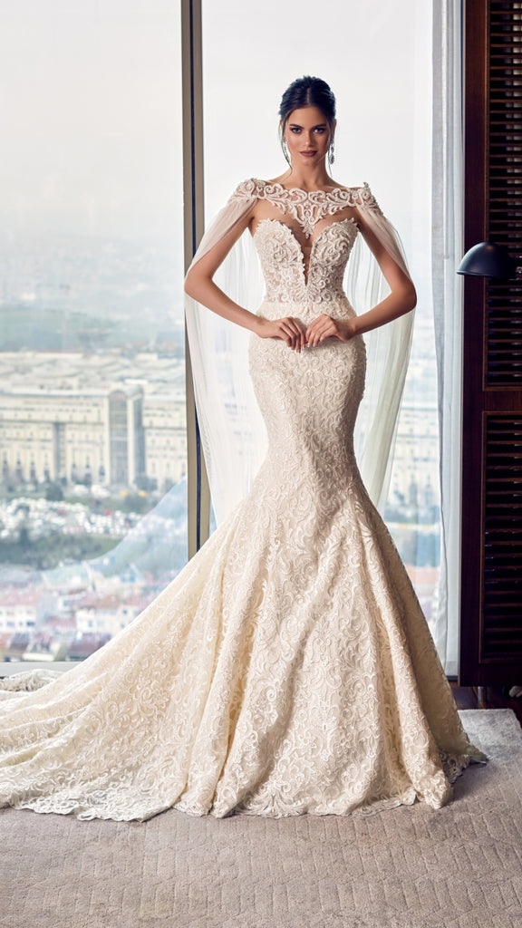 Woman wearing a lace wedding dress with a cityscape in the background